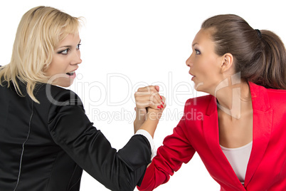 Arm wrestling of two smiling businesswoman