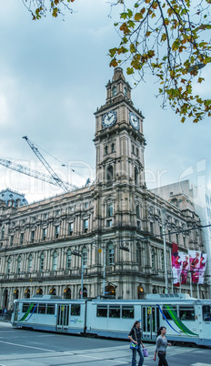 MELBOURNE - JULY 21, 2010: Tourists walk along city streets on a