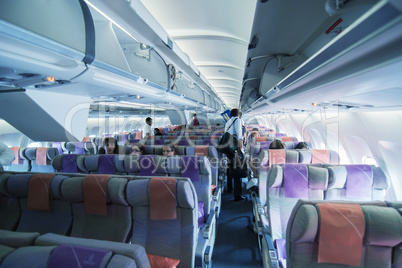 DUBAI, UAE - JULY 30, 2010: Tourists take a seat on a Emirates f