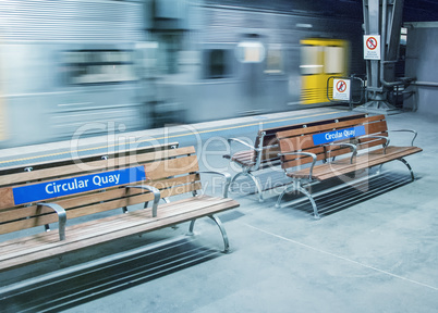 Benches with moving train in Circular Quay subway station, Sydne