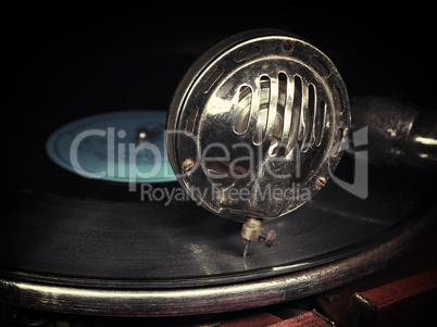 Head with an old gramophone needle on the vinyl disc