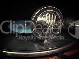 Head with an old gramophone needle on the vinyl disc