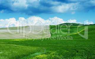 Green and brown meadows under a cloudy sky