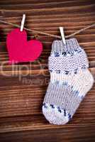 Baby Sock with red Heart on Wood