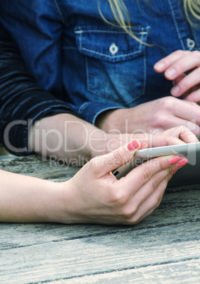 Girl using tablet outdoor on a table
