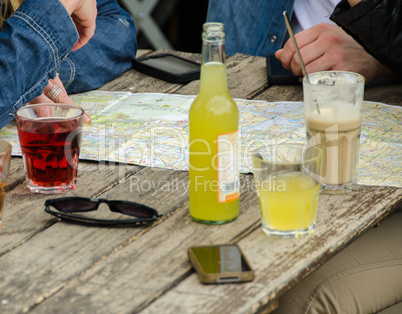 People with tecno gadgets checking map on a table