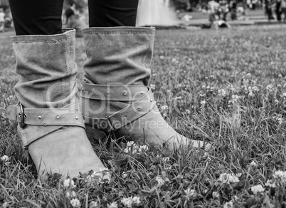 Woman boots on a green garden