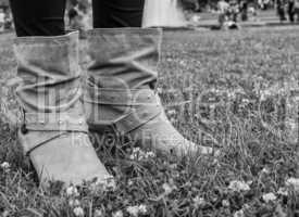 Woman boots on a green garden