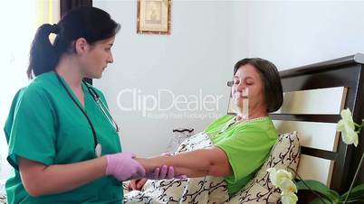 Nurse bandaging up an injured senior woman arm