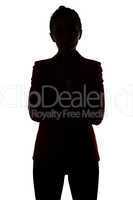 Silhouette of businesswoman with arms crossed