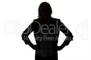 Silhouette of businesswoman with hands on hips
