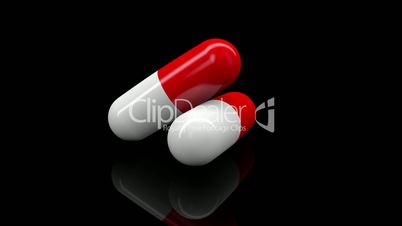 Two pills in white and red colors rotating on black background.