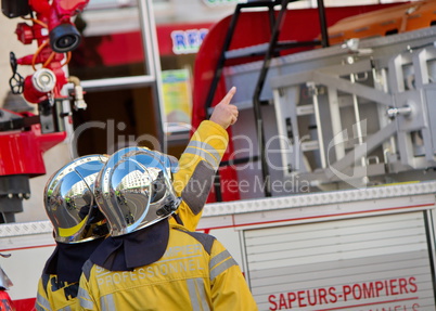 Firefighters discussing next to fire truck, Geneva, Switzerland