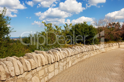 Stone wall sidewalk.