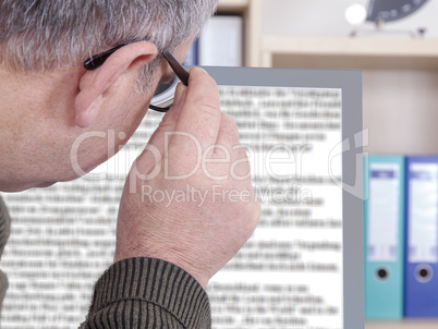 Man with glasses looking at screen