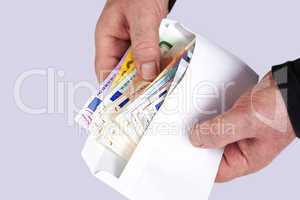 Hand holding envelope with paper money