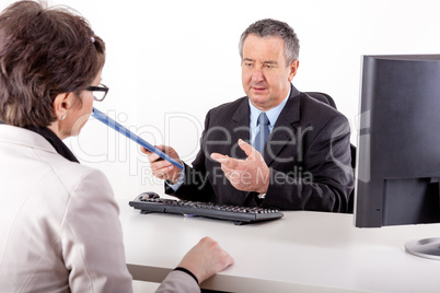 Businessman and businesswoman with documents in the office