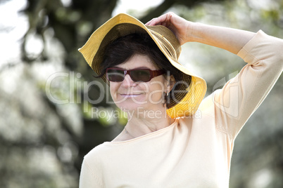 Women portrait with straw hat under blooming cherry tree old