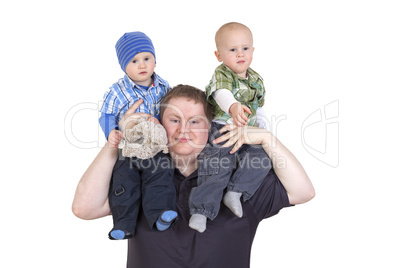 Father carrying his twin children on shoulders