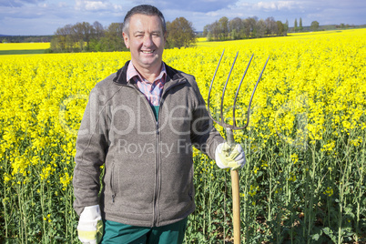 Farmer with fork on the field