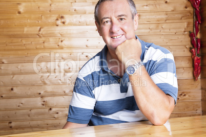 Man with head propped sitting at the table