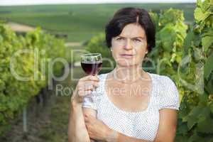 Woman in vineyard holding wine glass