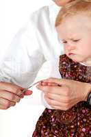 Woman cuts toddler's fingernails