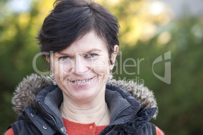 Portrait of a middle aged woman in autumn