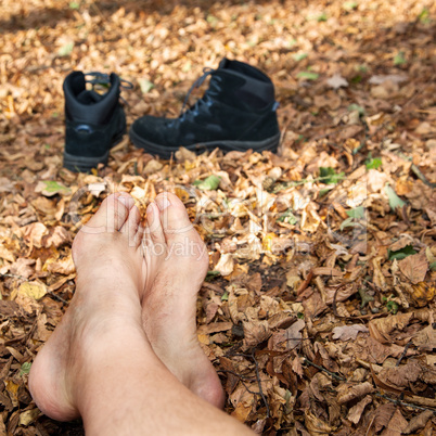 Shoes and Bare feet in autumn leaves