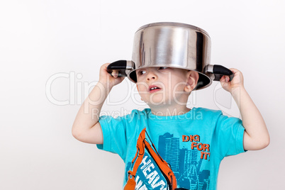 Child holding cooking pot on his head