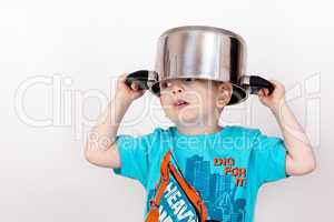 Child holding cooking pot on his head