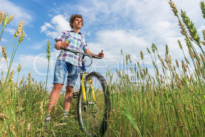 Portrait of a boy with a bicycle