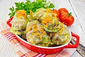 Cabbage stuffed and carrots in pan on napkin