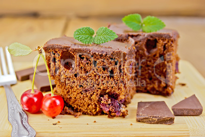 Cake chocolate with cherries on board