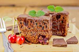 Cake chocolate with cherries on board