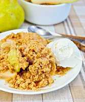 Crumble with pears in bowl on linen tablecloth