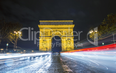Traffic flow in Paris. Car light trails in front of Arc de Triom