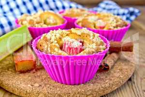 Cupcakes with rhubarb in tins on board