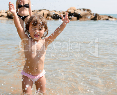 Baby playing with sea water at the beach