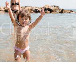 Baby playing with sea water at the beach