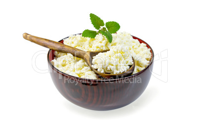 Curd in wooden bowl with spoon and mint