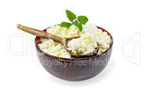 Curd in wooden bowl with spoon and mint