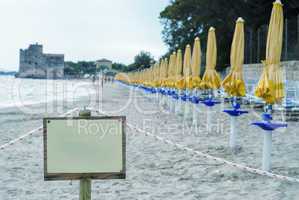 Desert beach with empty signboard