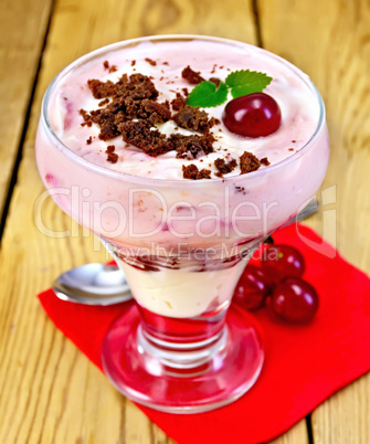 Dessert milk with cherry and biscuit on paper napkin
