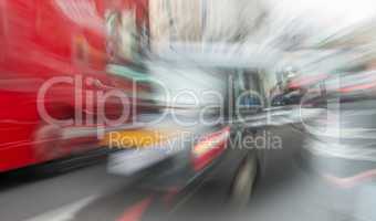 Blurred movement of London black cab and red bus in city traffic