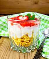 Dessert milk with strawberry and flakes in glass on board