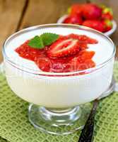 Dessert milk with strawberry in goblet on napkin