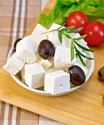 Feta with olives and tomato on brown cloth