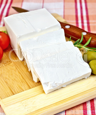 Feta with olives and tomatoes on a red fabric
