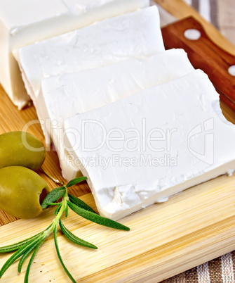 Feta with olives on a brown cloth